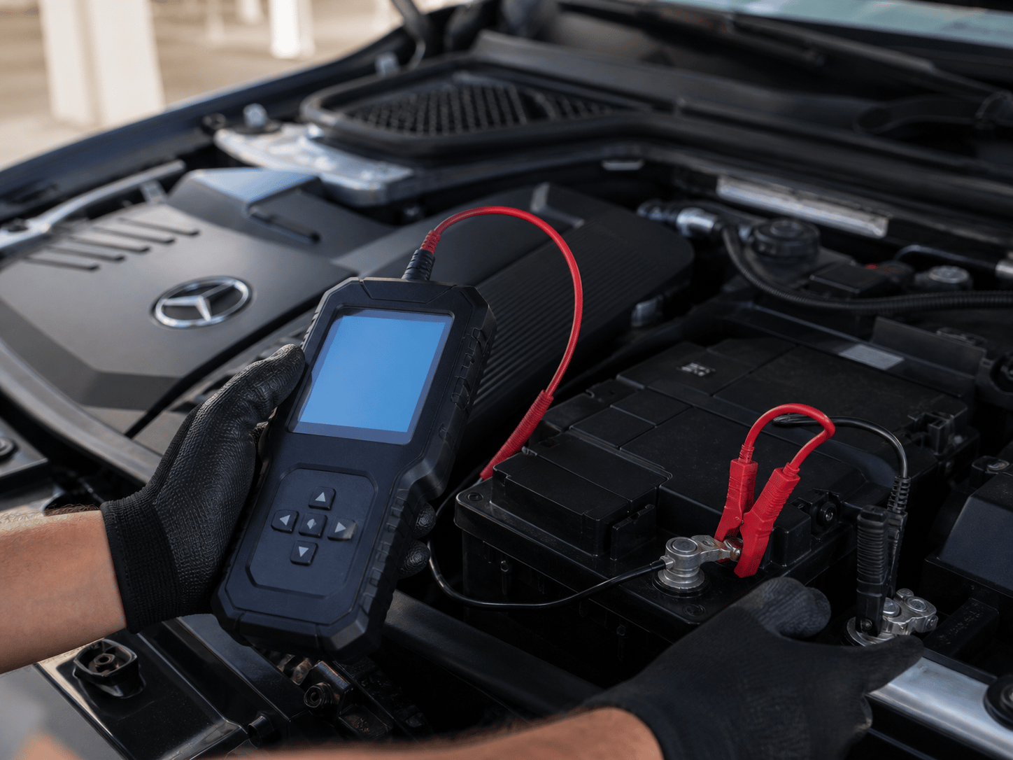 A battery tester connected to a car battery